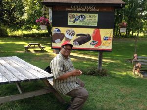 Image of man sitting at picnic table